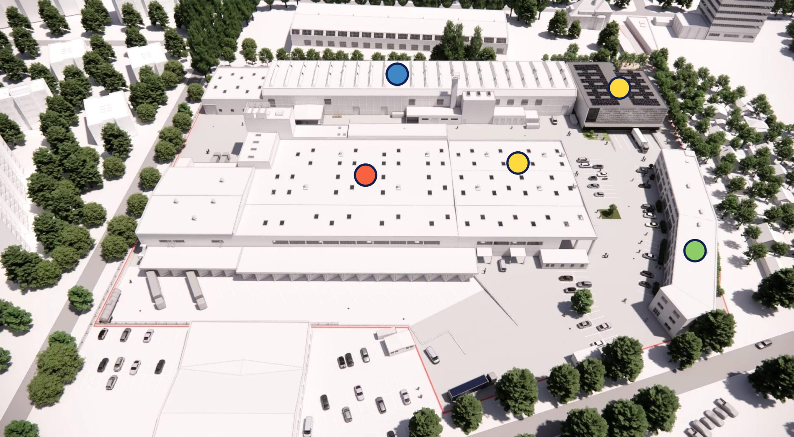 Luftaufnahme eines Gebäudekomplexes mit farbigen Markierungen